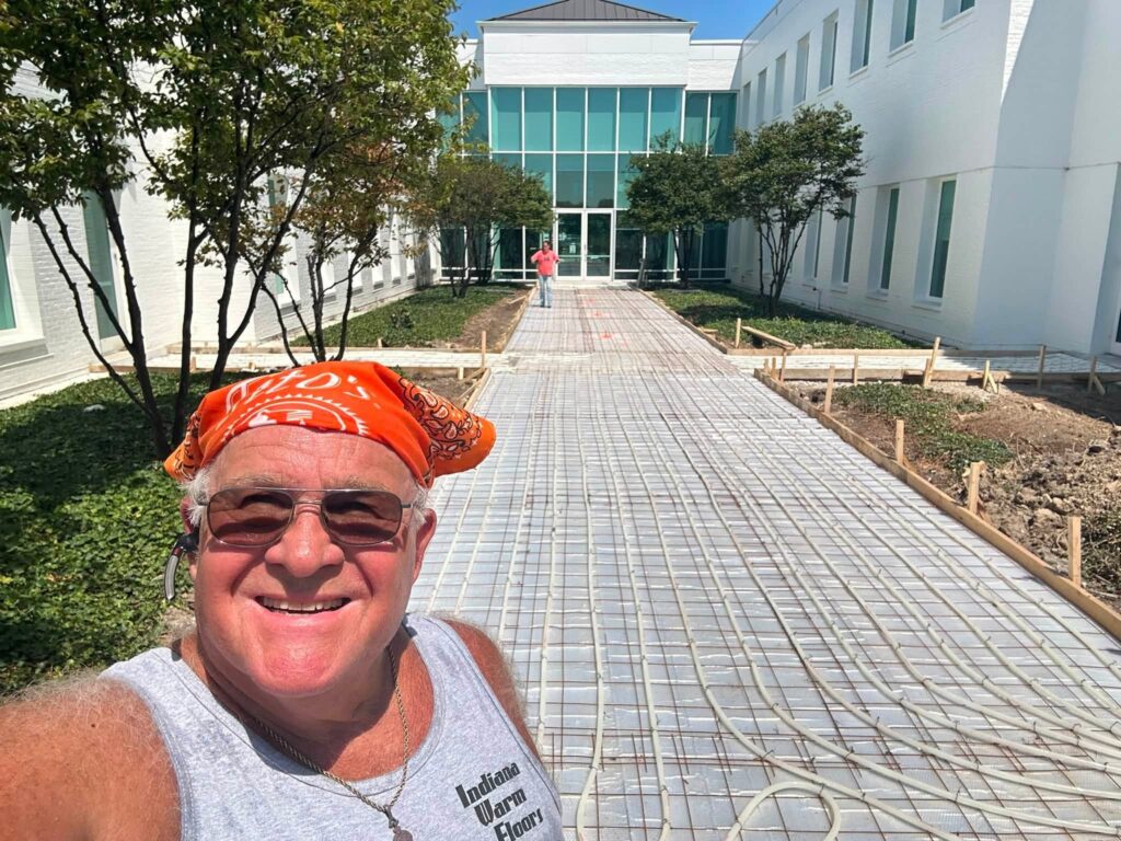 Snow-melt tubing installed across a commercial courtyard walkway before the concrete pour